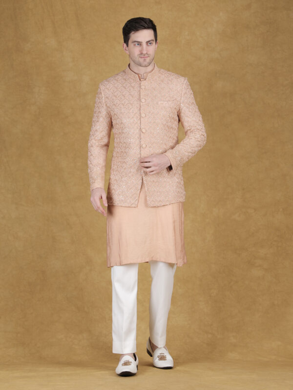 Peach reception bandhgala with thread and hand embroidery featuring detailed handcrafted texture