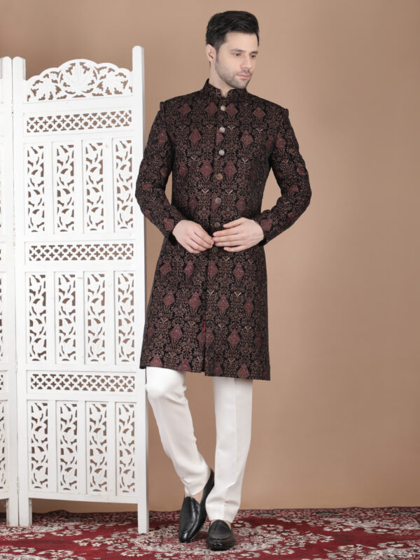 Maroon reception sherwani with dense zari embroidery and traditional repeating pattern design