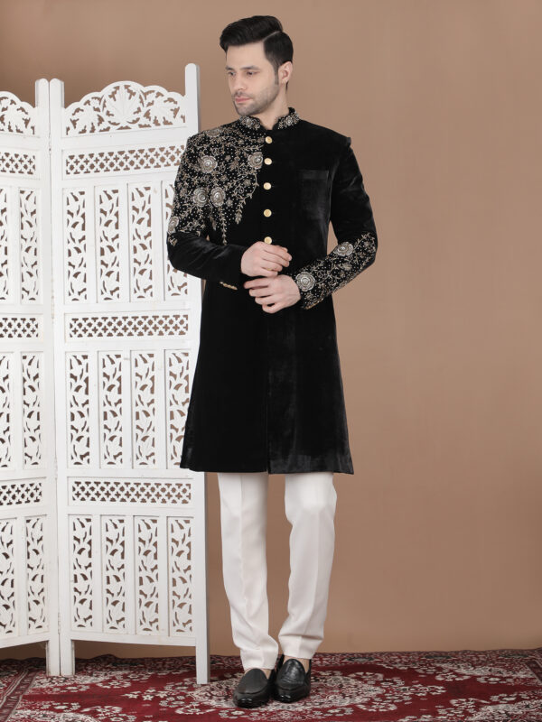 Black reception sherwani with antique gold zari embroidery on velvet with heavy shoulder and sleeve detailing