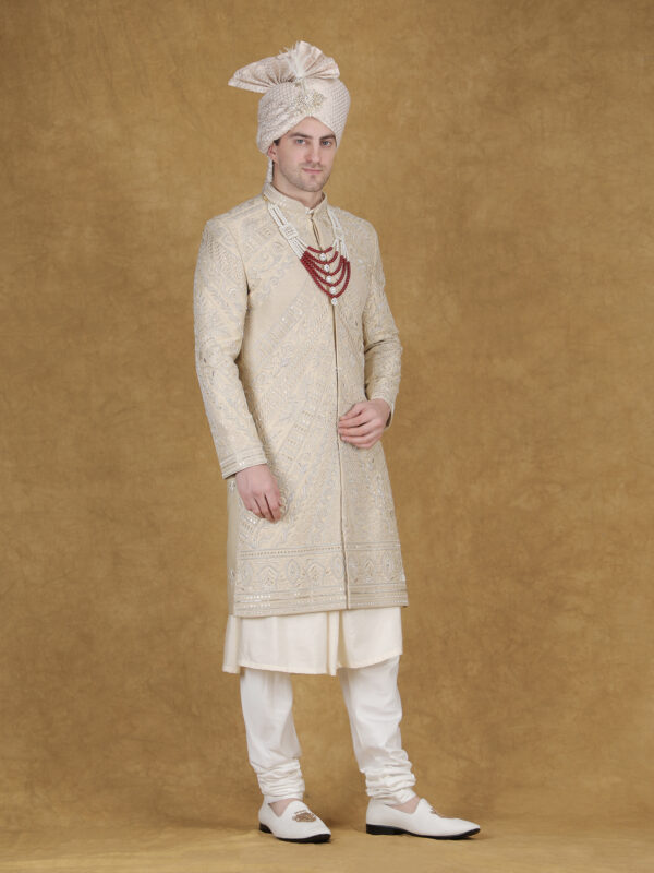 Beige heavy thread and zari embroidery sherwani for groom with diagonal detailed royal wedding design