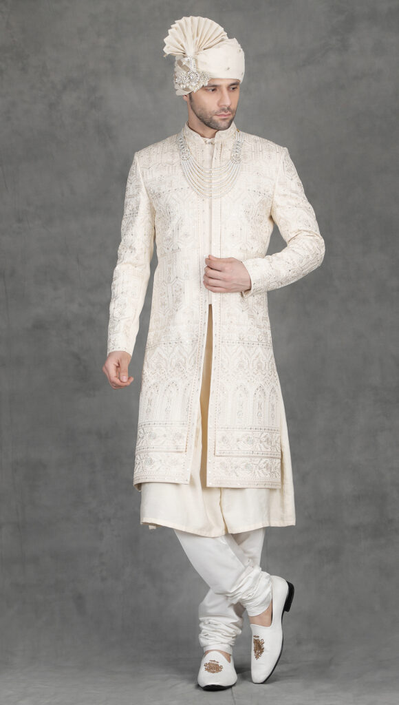 Ivory heavy thread and zari embroidery sherwani for groom with architectural pattern embroidery and royal wedding look