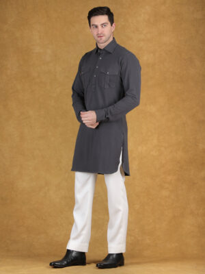 PRODUCT DESCRIPTION This Charcoal Knitted Pathani Kurta Set is crafted for reception occasions where modern structure meets everyday comfort. The kurta features a Pathani-inspired silhouette with a shirt-style collar, front placket, and dual chest pockets, which adds a bold and utility-driven appeal. The charcoal tone creates a strong and sophisticated presence, while the knitted fabric enhances flexibility and comfort. Therefore, this Charcoal Knitted Pathani Kurta Set becomes a perfect choice for men who want a clean, modern, and confident outfit for reception events. Moreover, the minimal yet structured design ensures a sharp and refined look. Fabric & Craftsmanship This set includes a kurta paired with trouser or pajama, both tailored with precision. The knitted fabric offers a soft texture with slight stretch, so it ensures ease of movement throughout the day. The chest pockets are neatly constructed with flap detailing, which adds both function and style. Also, the stitching is clean and durable, so the outfit maintains its structure over time. In addition, the breathable nature of the fabric keeps the outfit comfortable while maintaining a polished appearance. Modern Knitted Ethnic Set Styling & Occasions This outfit is ideal for reception functions, evening gatherings, and modern festive occasions. The charcoal color provides a bold and versatile base, while the Pathani design adds a contemporary edge. Therefore, you can carry this look with confidence and effortless style. Utility Kurta Outfit Styling Tips Pair this kurta set with white or charcoal trousers for a balanced and sharp look. Keep accessories minimal to maintain a modern aesthetic. Complete the outfit with loafers or ethnic footwear for a refined finish. Available Sizes XS, S, M, L, XL, XXL, and custom tailoring options available. Why Choose Deshi Coast? At Deshi Coast, we focus on modern ethnic wear using premium fabrics and functional designs, so every outfit delivers comfort, durability, and style. Care Instructions Dry clean or gentle wash recommended to maintain fabric quality. Delivery & Custom Tailoring Custom tailoring available with reliable delivery across India.